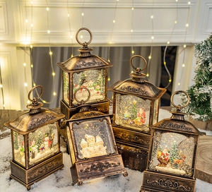 Detailed view of five vintage bronze Christmas lanterns with snow scenes and warm lighting