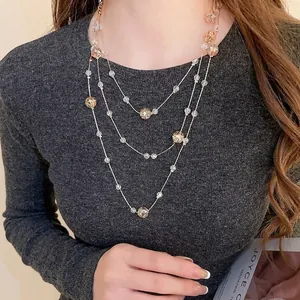 Elegant three-layer crystal beaded necklace featuring champagne and clear faceted glass stones