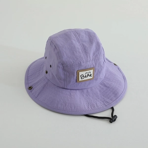 Detail of quick-dry sun hat showing breathable metal eyelet and BEAR label patch