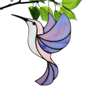Detail of purple and pink hummingbird suncatcher with stained glass texture and metal chain