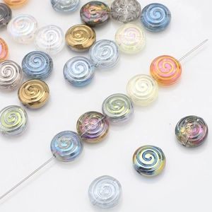 Macro detail of spiral textured glass candy beads on needles for DIY jewelry making