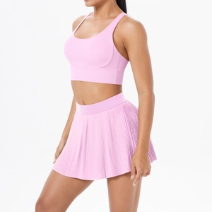 Detail of light pink athletic set featuring pleated sports skirt and U-neck sports bra