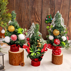 Miniature pine needle Christmas trees with red berries and wood bases for holiday decor