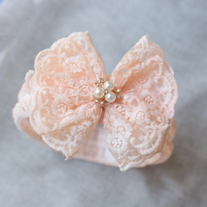 Pink baby lace headband with large bow featuring faux pearls and sparkling rhinestones
