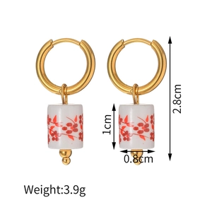 Detailed view of 18K gold earrings with blue and white porcelain beads and size dimensions