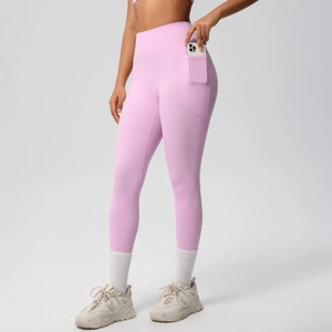 Detail shot of pink high-waisted yoga leggings featuring a practical side phone pocket