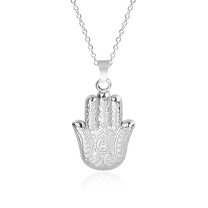 Vue détaillée du pendentif Main de Fatma avec motifs ondulés et textures en spirale argent