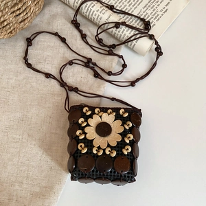 Detail of bohemian wooden bead shoulder bag with handmade resin flower and coconut shell accents
