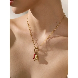 Gold paperclip chain necklace with red cornicello and mano cornuta hand charm pendants