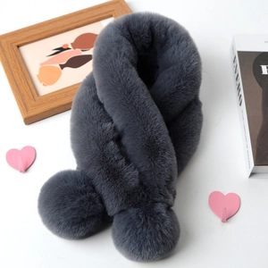 Detail of dark grey faux fur scarf with pom-pom ends and elegant criss-cross design