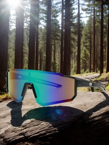Close-up of rainbow gradient sports sunglasses lens with outdoor forest reflection