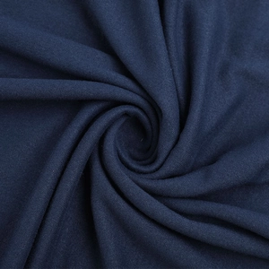 Detail of dark blue knit fabric showing soft texture and premium spiral drapery