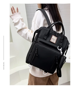 Detailed back view of the black multi-functional diaper backpack with small round coin purse