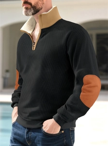 Detail of men's half-zip sweatshirt featuring camel color-block elbow patches and collar