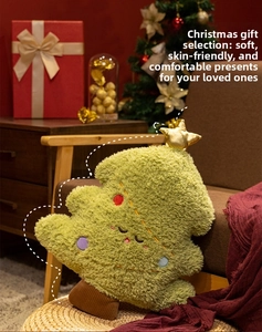 Detailed plush Christmas tree pillow with golden star and soft green embroidery texture