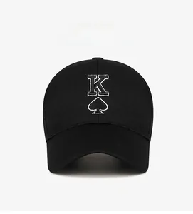 Detailed close-up of white King of Spades embroidery on black cotton baseball cap