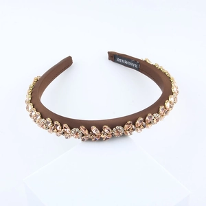 Close-up of handmade baroque headband with pink and champagne crystal flower patterns