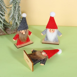Three handcrafted wooden Christmas gnomes with felt hats and fur beards for holiday decor