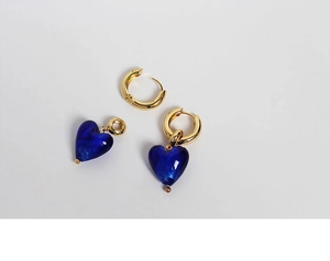 Detail showing the detachable gold hoops and translucent blue heart-shaped pendants