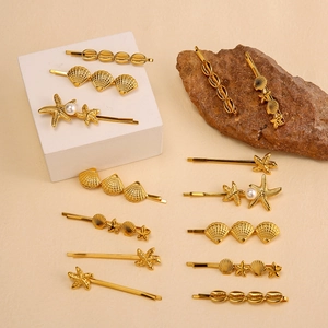 Detailed close-up of gold ocean-themed starfish and shell hair clips with pearl accents