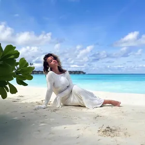 Elegant white backless long sleeve dress with flare sleeves for beach vacation style