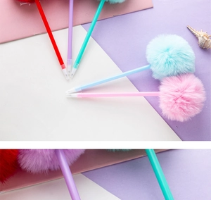 Close-up of colorful plush pom-pom pens with smooth plastic barrels and vibrant ink