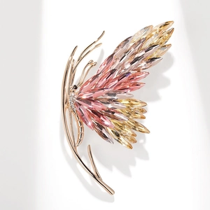 Close-up of butterfly brooch with sparkling crystals and rose gold plated alloy base