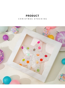 Detail of white star ornament with colorful glitter polka dots in festive gift box