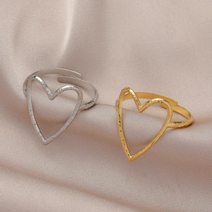 Adjustable hollow heart rings in silver and gold with hammer texture on silk cloth