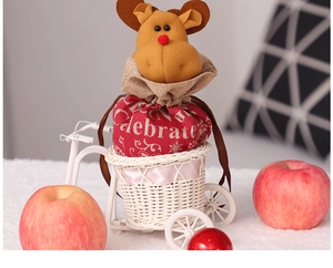 Christmas reindeer drawstring gift bag displayed in a decorative white bicycle model