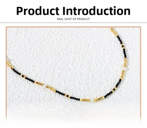 Detailed macro view of black spinel beads, polished brass cubes, and white rice pearls