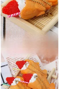 Detailed view of artificial Taiyaki keychain with realistic strawberry and cream toppings
