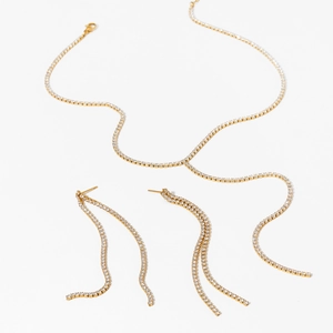 Luxurious gold Y-shaped zircon necklace and tassel earrings set on white background