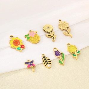 Detail of colorful enamel flower and fruit pendants including sunflower and pineapple charms