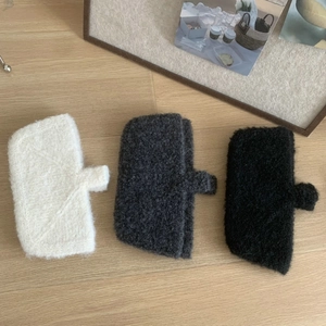 Detail showing high-quality knitted wool texture in white, dark grey and black colors