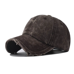 Detailed macro view of distressed retro baseball cap with vintage washed fabric and ripped brim