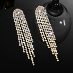 Detailed macro view of luxury gold fringe earrings with shimmering colorful rhinestones