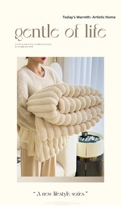 Detail of thickened cream white faux fur blanket with 3D vertical stripe texture design