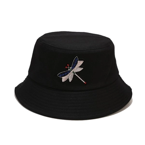 Black cotton bucket hat featuring detailed dragonfly embroidery for sun protection