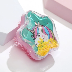 Detail of star-shaped hairbrush featuring floating glitter and a colorful unicorn print