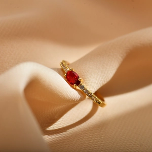 Elegant gold open ring for couples featuring a red oval zircon and side accent diamonds