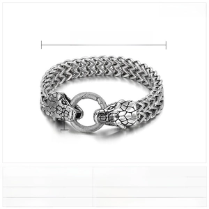 Macro detail of punk double snake head stainless steel bracelet with woven chain