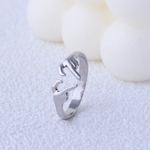 Macro shot of silver adjustable ring featuring a creative heart gesture hand design
