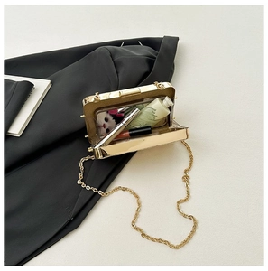 Internal view of gold metallic evening clutch showing space for phone and makeup accessories