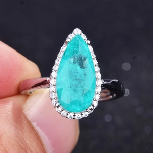 Pear-cut Paraiba green gemstone ring with halo diamonds on a silver band