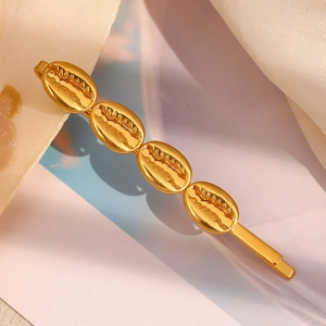 18K gold plated stainless steel hair clip featuring four nautical seashell ornaments