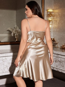 Detail of champagne gold satin sleepwear with delicate straps and glossy finish