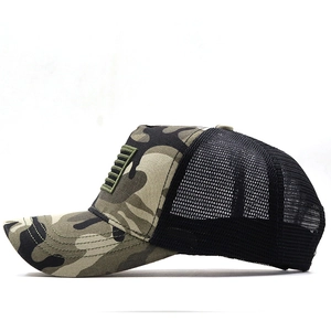 Detail of camouflage baseball cap featuring breathable black mesh and American flag patch
