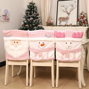 Detailed view of pink Christmas chair covers with plush Santa, Snowman and Reindeer