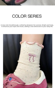 Detail of beige crew socks with pink scalloped edges and delicate bow embroidery